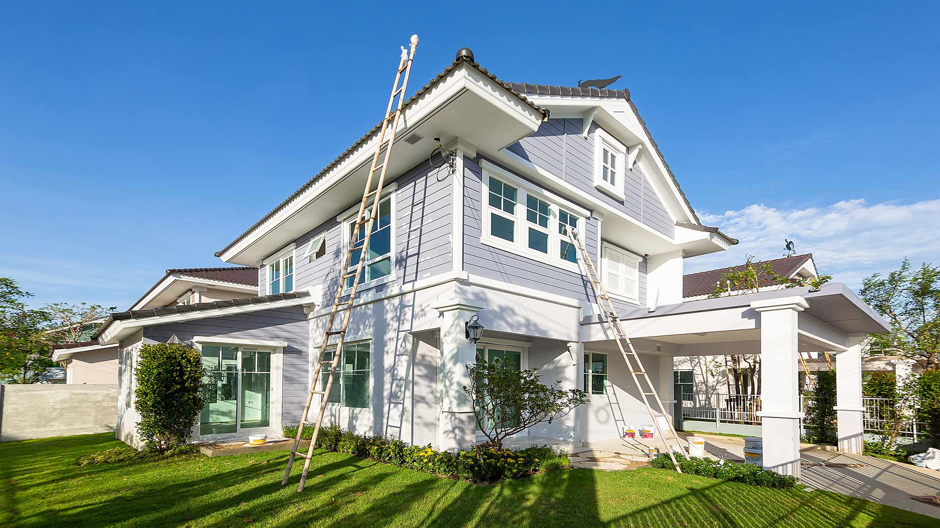 home exterior with ladders for painting
